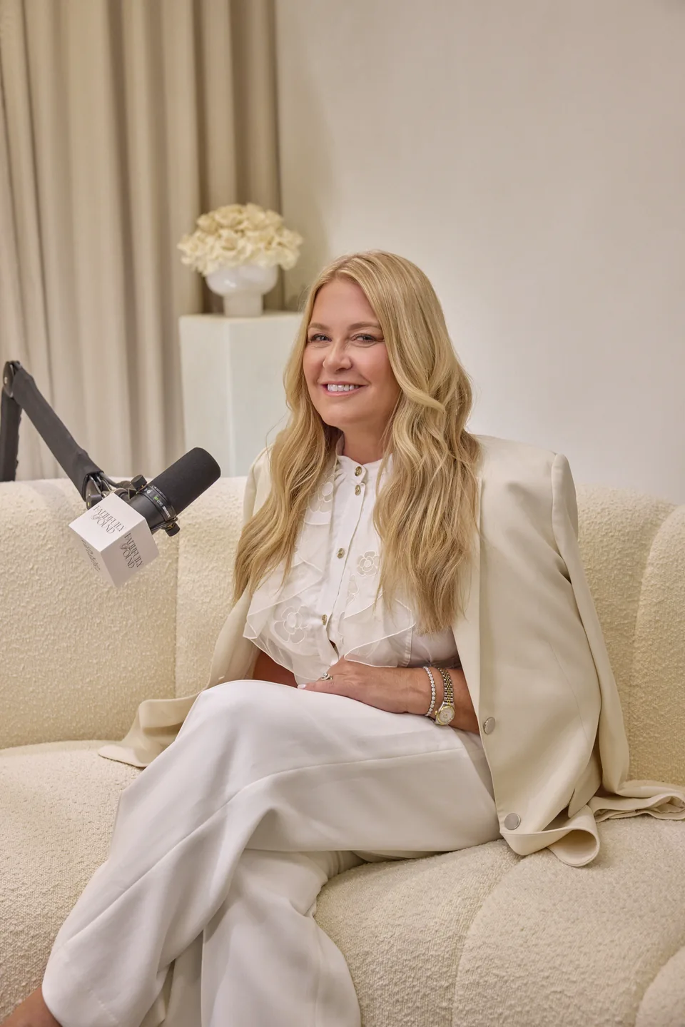 Amy Lacey smiling while seated at the Faithfully Found podcast microphone