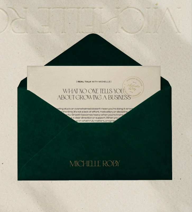 Michelle Roby’s branded letter inside a deep green envelope with gold lettering
