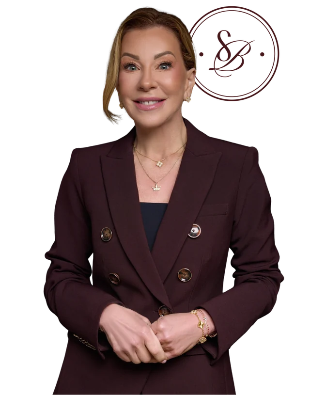 Dr. Stephanie Byerly in a burgundy suit with her personal brand monogram