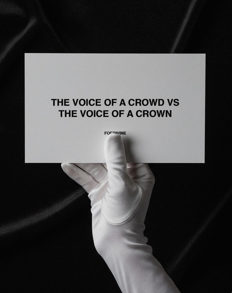 A white-gloved hand holds a FORDIVINE card reading: The voice of a crowd vs the voice of a crown.